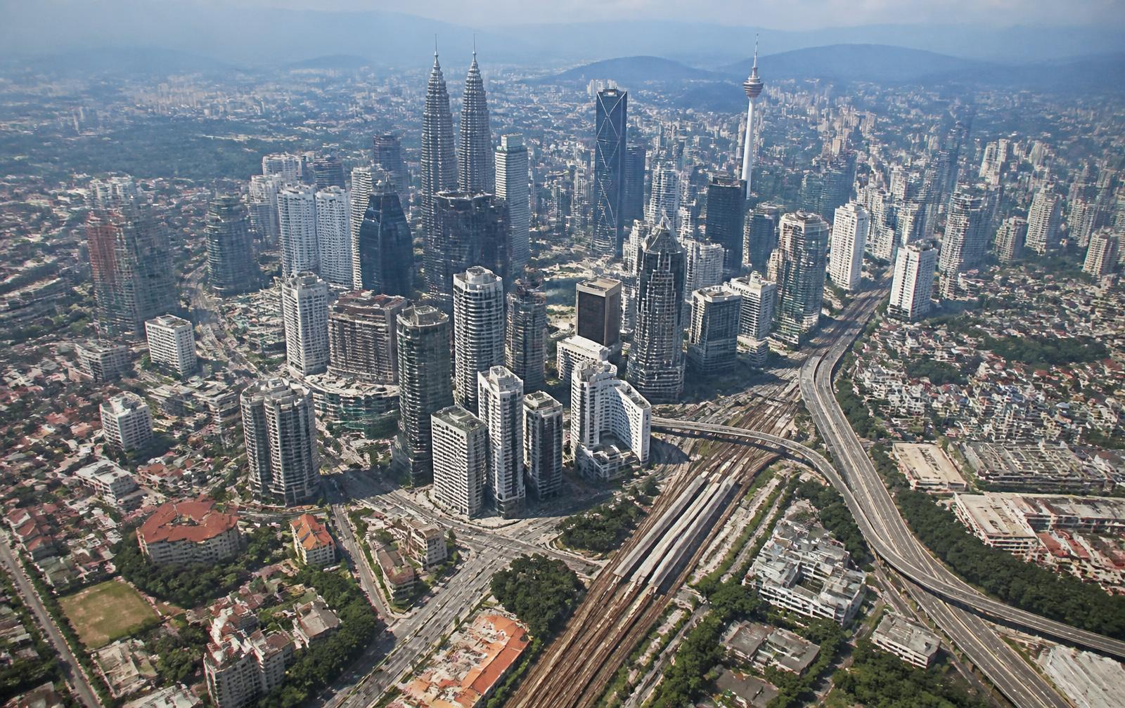 Aerial view of Kuala Lumpur showing office towers, highways and rail infrastructure